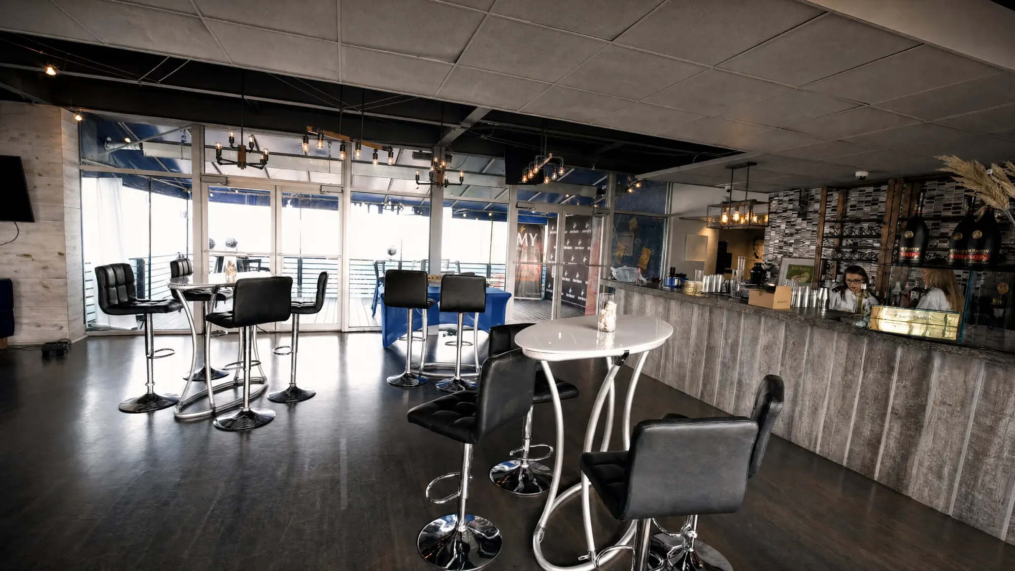 The Club's own bar and the glass doors open to the deck over the water
