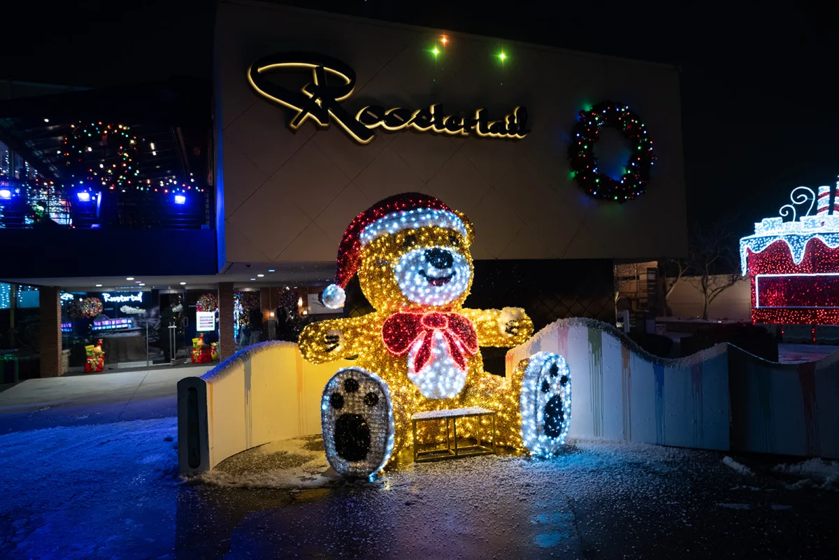 The Roostertail lit up for the holidays at night, seen from the water side