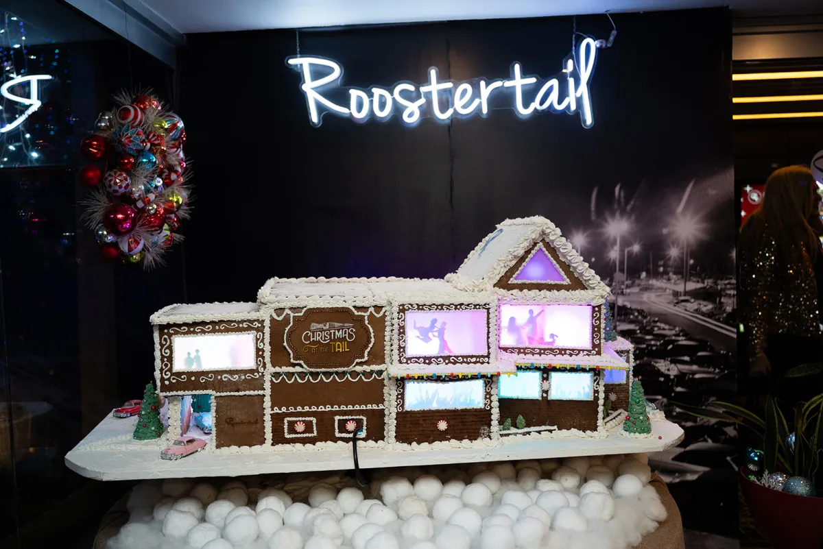 A gingerbread replica of the Roostertail, neon script sign included, on display for one December company party.