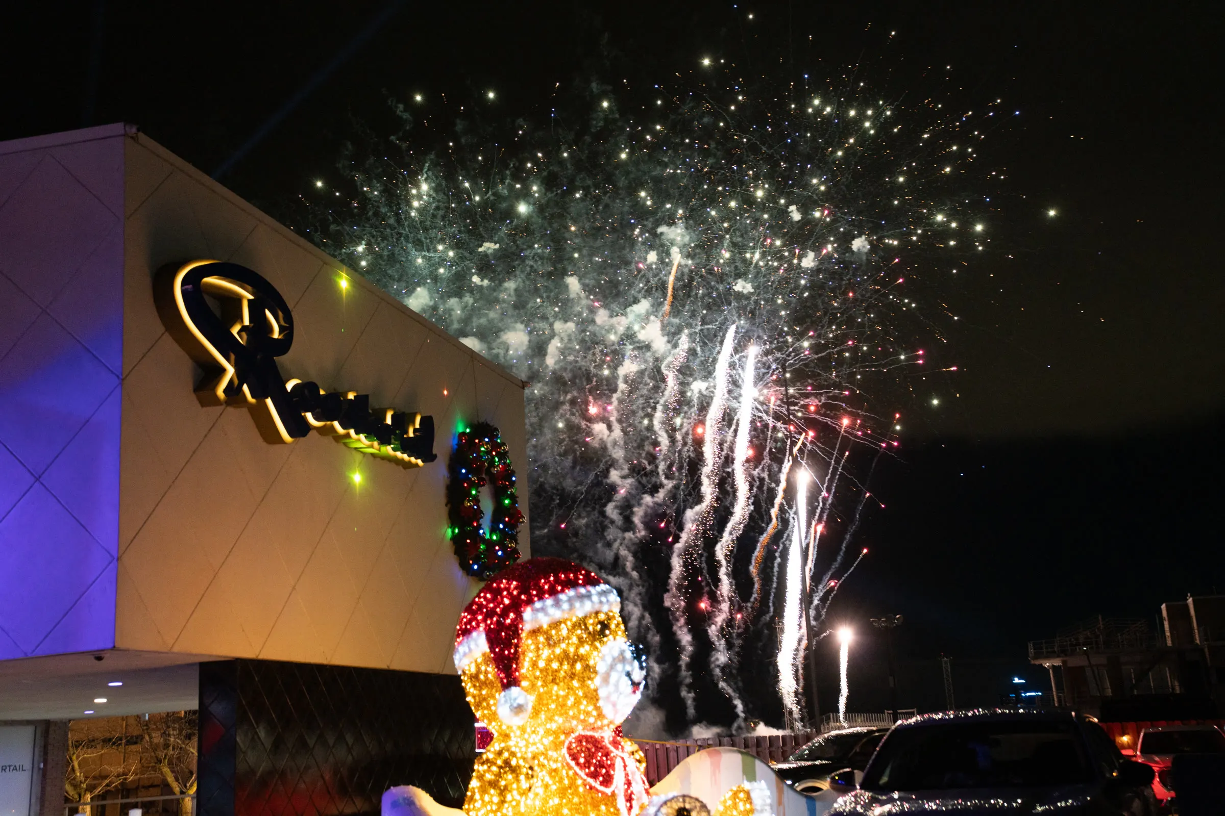 Fireworks over the Roostertail, lit for the holidays, with the light-up bear out front
