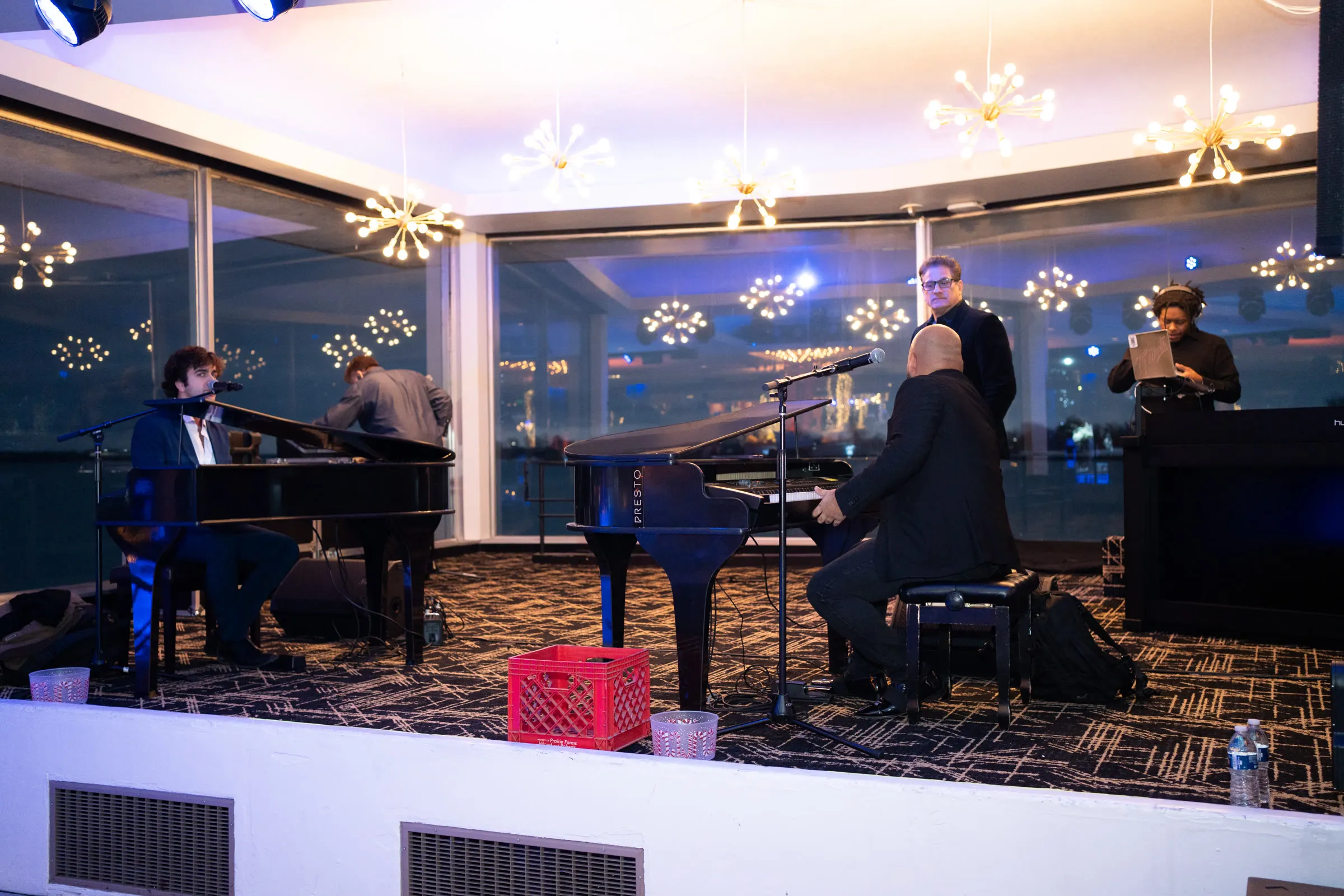 A pianist playing under hanging snowflakes in the Marine Room