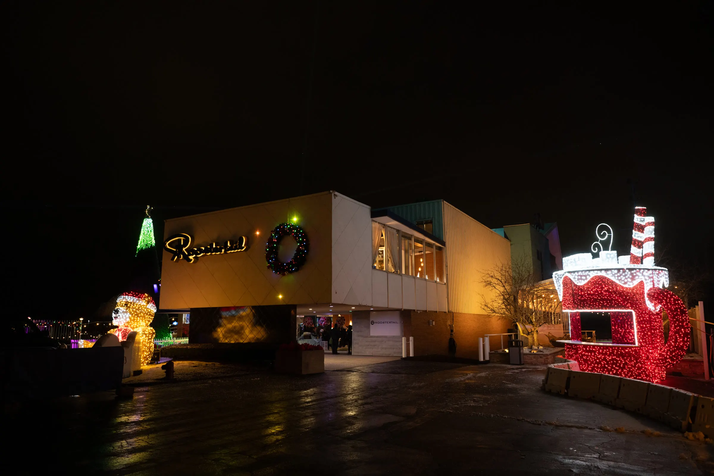 The Roostertail lit for the holidays at night, light-up figures out front